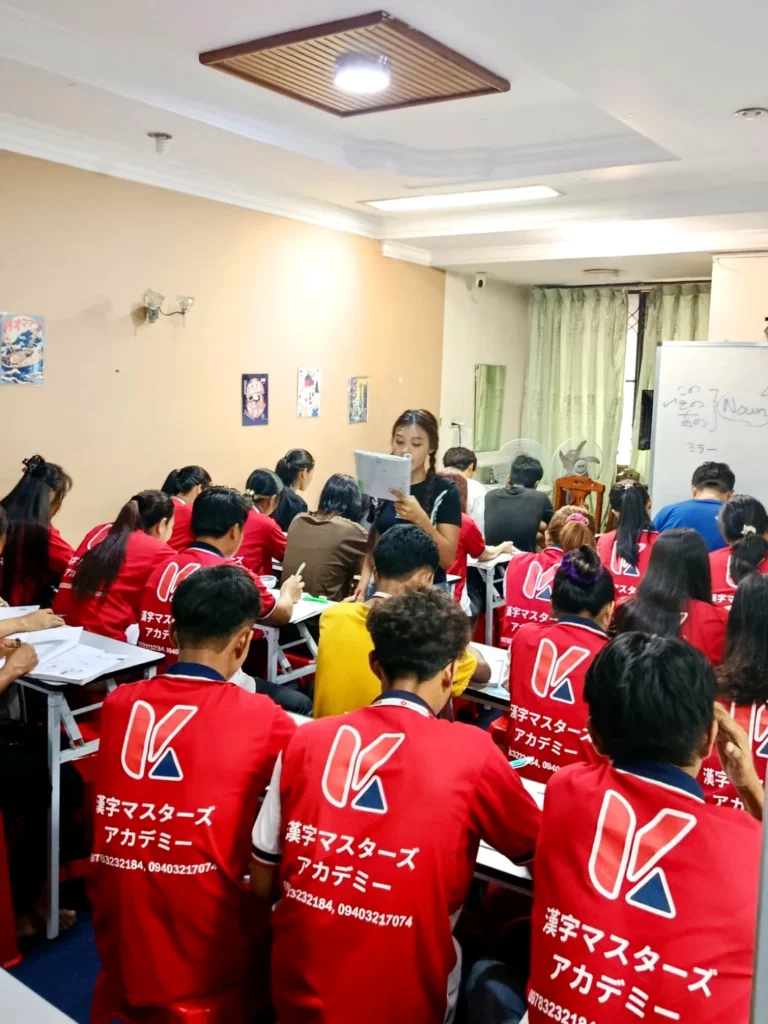 Kanji Masters Academy students wearing red KMA uniforms in class